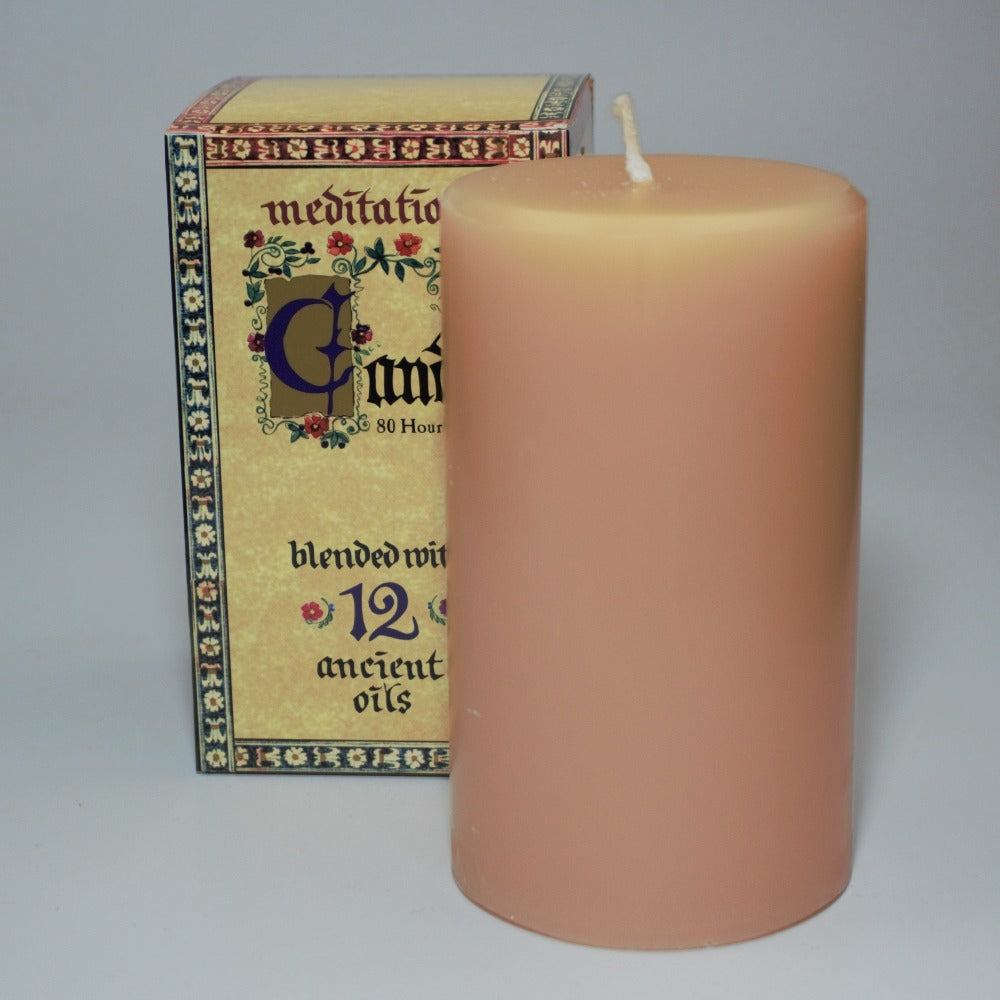 meditation candle 80 hour burn time, sitting in front of its packaging box, on a white background