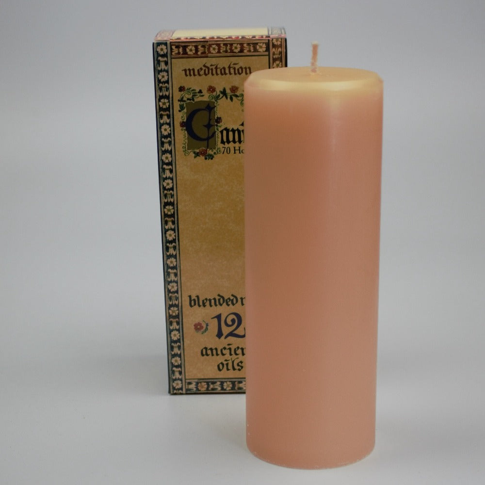meditation candle in front of it's packaging box on white background