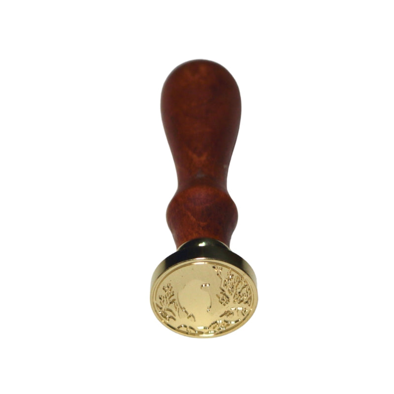 Brass wax seal stamp of a raven sitting on a tree on a wooden handle