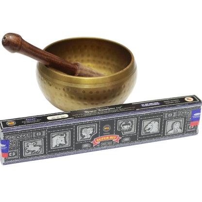 black box- satya brand "super hit" incense in front of brass singing bowl with wooden striker