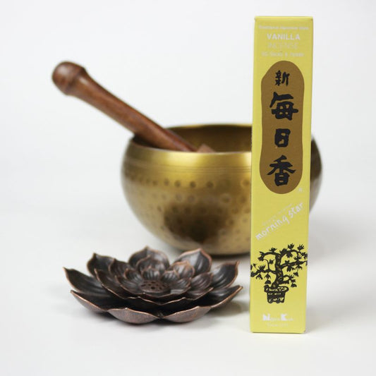  rectangle box of japanese morning star "Vanilla" incense sticks next to a lotus incense holder and brass singing bowl